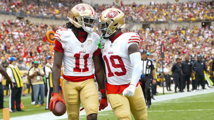 49ers wide receiver Deebo Samuel congratulates teammate Brandon Aiyuk for catching a touchdown pass against the Steelers at Acrisure Stadium.