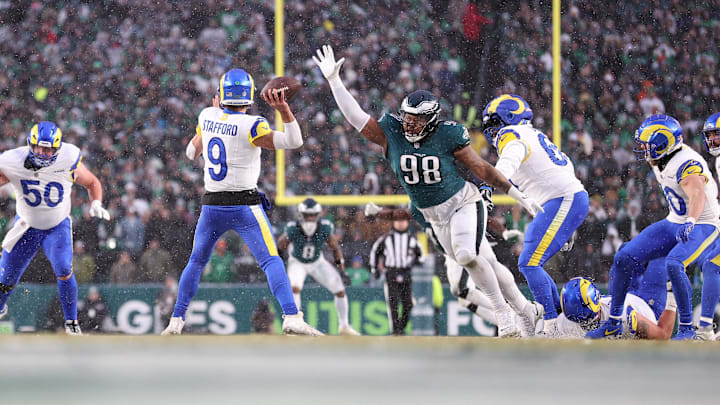 Los Angeles Rams quarterback Matthew Stafford throws the ball as Philadelphia Eagles defensive tackle Jalen Carter pressures.