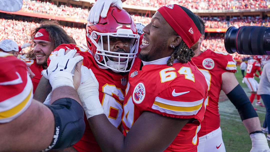 Nov 10, 2024; Kansas City, Missouri, USA; Kansas City Chiefs offensive tackle Wanya Morris (64) celebrates with defensive tackle Mike Pennel Jr. (69) after the win over the Denver Broncos at GEHA Field at Arrowhead Stadium. Mandatory Credit: Denny Medley-Imagn Images
