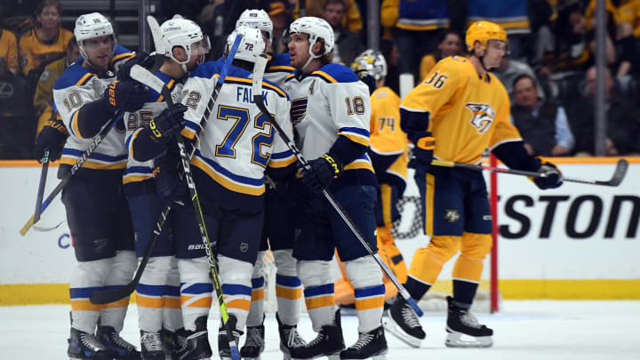 Apr 4, 2024; Nashville, Tennessee, USA; St. Louis Blues center Jordan Kyrou (25) celebrates with teammates after a goal during the third period against the Nashville Predators at Bridgestone Arena. Mandatory Credit: Christopher Hanewinckel-USA TODAY Sports