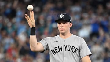 Jul 23, 2025; Toronto, Ontario, CAN;  New York Yankees first baseman Ben Rice (22) flips the ball away after committing a fielding error that led to a Toronto Blue Jays run in the sixth inning at Rogers Centre. Mandatory Credit: Dan Hamilton-Imagn Images
