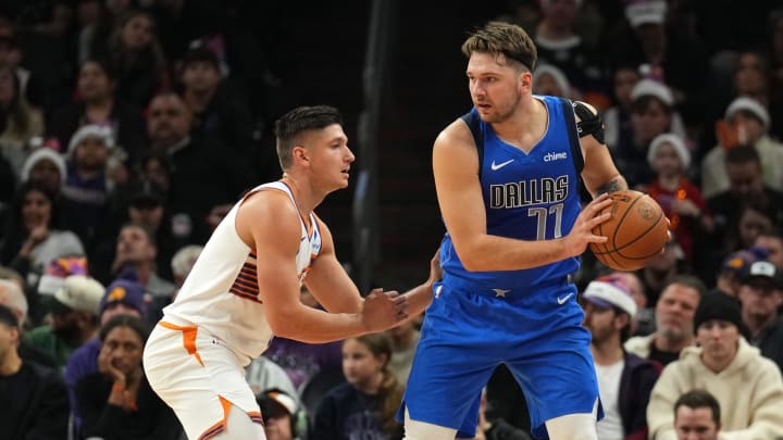 Dec 25, 2023; Phoenix, Arizona, USA; Phoenix Suns guard Grayson Allen (8) guards Dallas Mavericks guard Luka Doncic (77) during the first half at Footprint Center. Mandatory Credit: Joe Camporeale-USA TODAY Sports