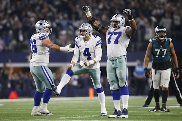 Dallas Cowboys QB Dak Prescott celebrates throwing a TD pass in the fourth quarter with G Xavier Su'a-Filo and OT Tyron Smith