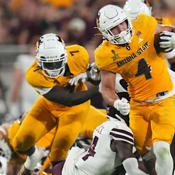 Arizona State running back Cam Skattebo (4) runs the ball as Mississippi State Bulldogs safety Isaac Smith (2) closes in at Mountain America Stadium on Sept. 7, 2024, in Tempe.