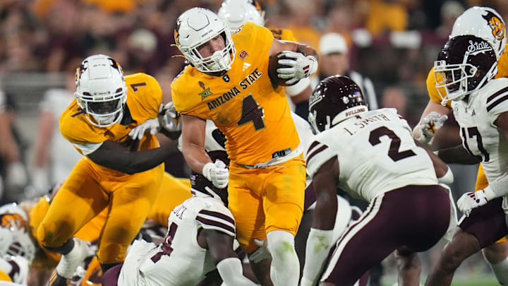 Arizona State running back Cam Skattebo (4) runs the ball as Mississippi State Bulldogs safety Isaac Smith (2) closes in at Mountain America Stadium on Sept. 7, 2024, in Tempe.