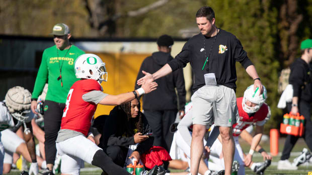 Oregon head coach Dan Lanning greets quarterback Dillon Gabriel during practice with the Oregon Ducks Tuesday, April 2, 2024 