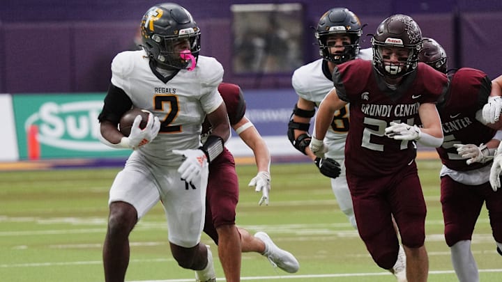 Regina's running back Savion Miller (2) runs with the ball for a first down against Grundy Center during the first quarter in the 1A High School state semi-final on Nov. 14, 2025, at UNI-Dome in Cedar Falls, Iowa.