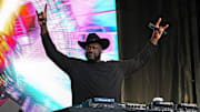 Shaquille O'Neal holds up the sign of the horns during a DJ performance ahead of the College Football Playoff semifinal game between the Texas Longhorns and Ohio State in the Cotton Bowl at AT&T Stadium.
