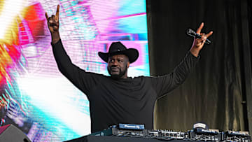Shaquille O'Neal holds up the sign of the horns during a DJ performance ahead of the College Football Playoff semifinal game between the Texas Longhorns and Ohio State in the Cotton Bowl at AT&T Stadium.