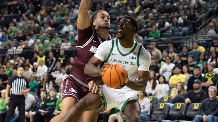 Oregon guard TJ Bamba presses toward the basket under cover from Montana guard Joe Pridgen as the Oregon Ducks host the Montana Grizzlies at Matthew Knight Arena on Friday, Nov. 8, 2024, in Eugene, Ore.