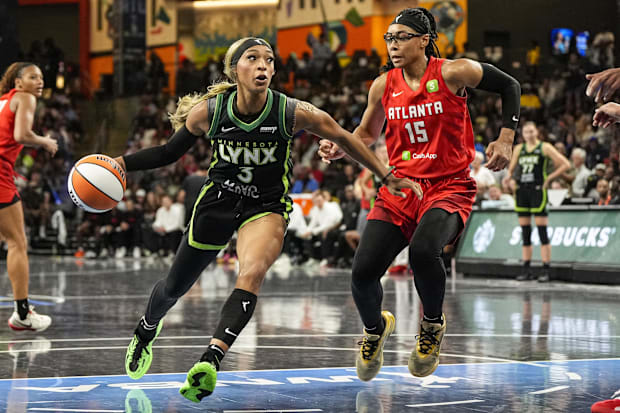 Minnesota Lynx guard DiJonai Carrington dribbles towards the basket against Atlanta Dream guard Allisha Gray. 