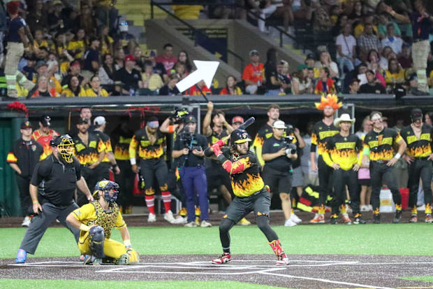 Firefighter Stephen Cullen bats during the first game of the Banana Ball Championship series.
