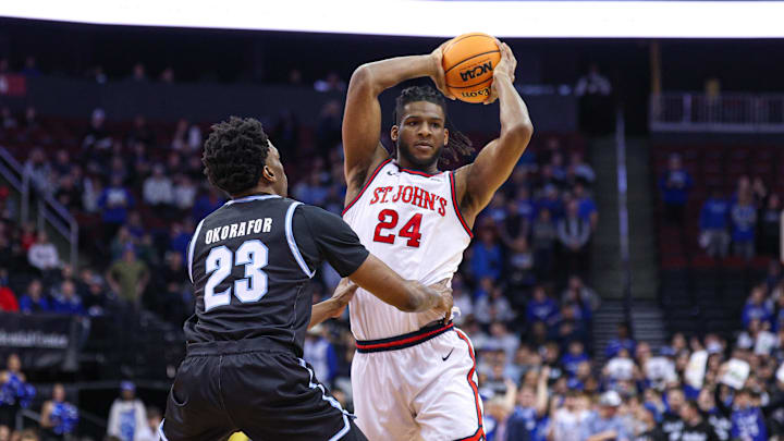 Jan 18, 2025; Newark, New Jersey, USA; St. John's basketball forward Zuby Ejiofor (24) looks to pass as Seton Hall Pirates center Emmanuel Okorafor (23) defends during the first half at Prudential Center.