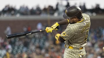 Sep 13, 2024; San Francisco, California, USA;  San Diego Padres first base Luis Arraez (4) hits a single during the first inning against the San Francisco Giants at Oracle Park. Mandatory Credit: Stan Szeto-Imagn Images