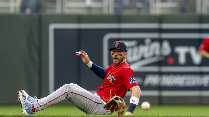 Apr 13, 2026; Minneapolis, Minnesota, USA; Boston Red Sox shortstop Trevor Story (10) looks on as he looses his glove attempting to field a ground ball against the Minnesota Twins in the first inning at Target Field. Mandatory Credit: Jesse Johnson-Imagn Images