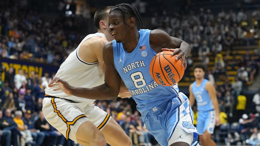 Jan 17, 2026; Berkeley, California, USA; North Carolina Tar Heels forward Caleb Wilson (8) dribbles against California Golden Bears forward John Camden (left) during the first half at Haas Pavilion. Mandatory Credit: Darren Yamashita-Imagn Images