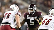 Nov 16, 2024; College Station, Texas, USA; Texas A&M Aggies defensive lineman Shemar Turner (5) defends in coverage against the New Mexico State Aggies during the first half at Kyle Field. Mandatory Credit: Maria Lysaker-Imagn Images 