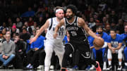 Feb 6, 2024; Brooklyn, New York, USA; Brooklyn Nets guard Spencer Dinwiddie (26) dribbles while being defended by Dallas Mavericks guard Luka Doncic (77) during the fourth quarter at Barclays Center. Mandatory Credit: John Jones-USA TODAY Sports