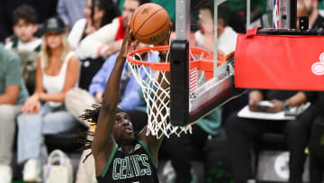 Jun 9, 2024; Boston, Massachusetts, USA; Boston Celtics guard Jrue Holiday (4) dunks and scores against the Dallas Mavericks during the second half of game two of the 2024 NBA Finals at the TD Garden. Mandatory Credit: USA TODAY Sports Images