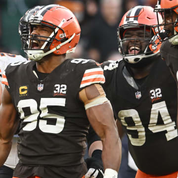 Dec 17, 2023; Cleveland, Ohio, USA; Cleveland Browns defensive end Myles Garrett (95) and defensive tackle Dalvin Tomlinson (94) and defensive end Alex Wright (91) celebrate after a tackle during the second half against the Chicago Bears at Cleveland Browns Stadium. Mandatory Credit: Ken Blaze-USA TODAY Sports