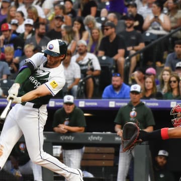 Colorado Rockies third baseman Ryan McMahon (24) hits a single against the Washington Nationals in the third inning at Coors Field on June 22.