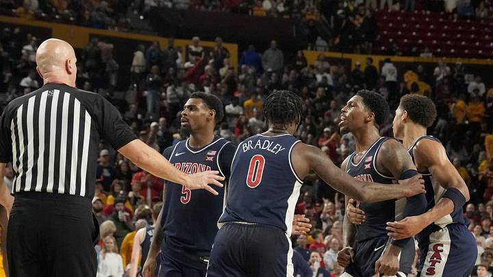 Arizona Wildcats guard Caleb Love (1) is held back by teammates during a Big 12 men's basketball game at Desert Financial Arena on Feb. 1, 2025. Both Arizona State Sun Devils guard BJ Freeman (10) and Love were ejected from the game.