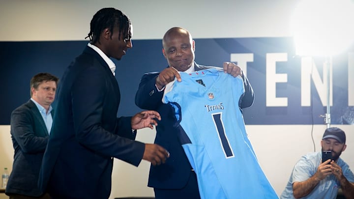 Cam Ward receives his jersey from former NFL player Warren Moon during a press conference at Ascension Saint Thomas Sports Park in Nashville, Tenn., Friday, April 25, 2025. The Titans selected quarterback Cam Ward from Miami with the first overall pick in the 2025 NFL Draft.