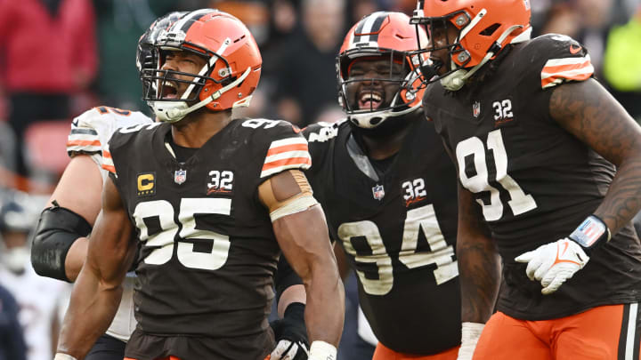 Dec 17, 2023; Cleveland, Ohio, USA; Cleveland Browns defensive end Myles Garrett (95) and defensive tackle Dalvin Tomlinson (94) and defensive end Alex Wright (91) celebrate after a tackle during the second half against the Chicago Bears at Cleveland Browns Stadium. Mandatory Credit: Ken Blaze-USA TODAY Sports