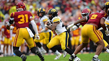 Nov 15, 2025; Los Angeles, California, USA; Iowa Hawkeyes running back Kamari Moulton (28) runs the ball against Southern California Trojans linebacker Jadyn Walker (31) during the first half at the Los Angeles Memorial Coliseum. Mandatory Credit: Gary A. Vasquez-Imagn Images