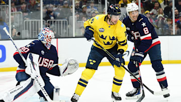 Feb 17, 2025; Boston, MA, USA; [Imagn Images direct customers only]  Team Sweden forward Adrian Kempe (10) and Team USA defenseman Zach Werenski (8) battle for position in front of goalie Jake Ottinger (30) during the second period in a 4 Nations Face-Off ice hockey game at TD Garden. Mandatory Credit: Bob DeChiara-Imagn Images