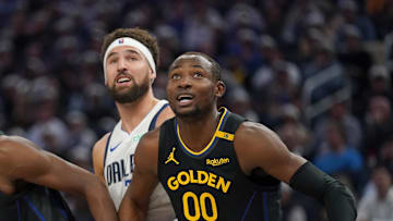 Nov 12, 2024; San Francisco, California, USA; Golden State Warriors forward Jonathan Kuminga (00) and forward Andrew Wiggins (22) battle for position with Dallas Mavericks guard Klay Thompson (31) in the second quarter at the Chase Center. Mandatory Credit: Cary Edmondson-Imagn Images