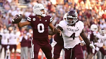 Oct 19, 2024; Starkville, Mississippi, USA;Mississippi State Bulldogs quarterback Michael Van Buren Jr. (0) drops back to pass against Texas A&M Aggies defensive lineman Shemar Stewart (4) during the third quarter at Davis Wade Stadium at Scott Field. Mandatory Credit: Matt Bush-Imagn Images