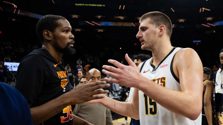 Dec 1, 2023; Phoenix, Arizona, USA; Denver Nuggets center Nikola Jokic (right) greets Phoenix Suns forward Kevin Durant following the game at Footprint Center. 