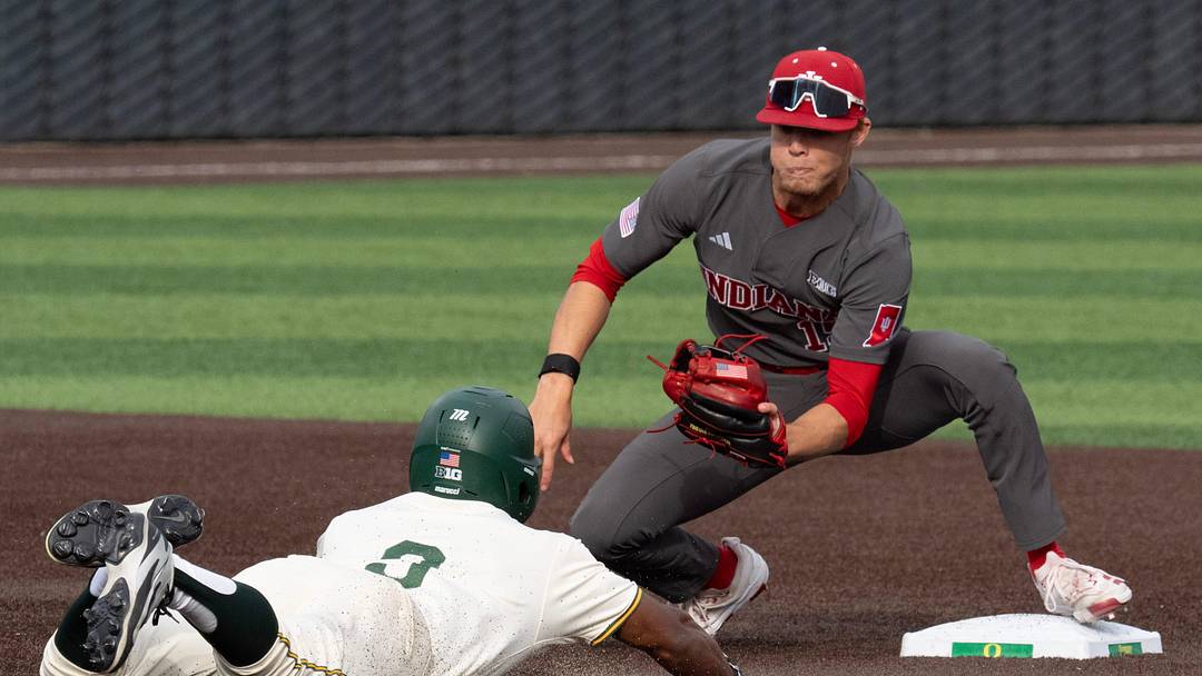 Oregon’s Elijah Cook, left, is caught trying to steal second by Indiana’s Cooper Malamazian during the third inning at PK Park in Eugene March 13, 2026.
