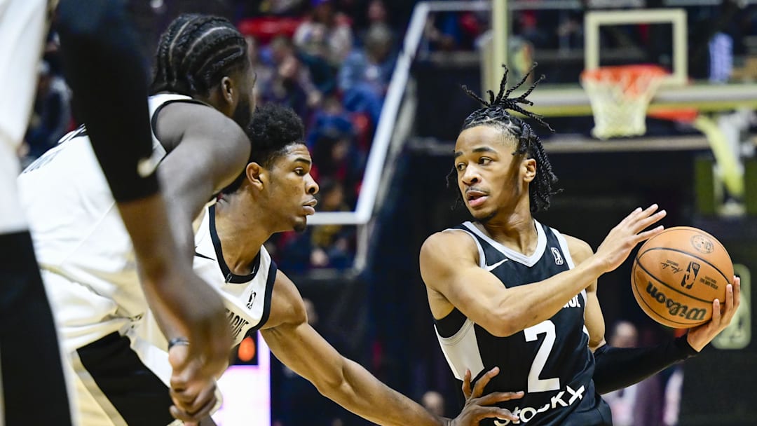Feb 19, 2023; Salt Lake City, UT, USA; Team Luka point guard Sharife Cooper (2) drives around Team Scoot guard Scoot Henderson (0) during the first half at the Jon M. Huntsman Center. Mandatory Credit: Christopher Creveling-Imagn Images