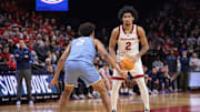 Dec 30, 2024; Piscataway, New Jersey, USA; Rutgers Scarlet Knights guard Dylan Harper (2) looks to pass during the second half as Columbia Lions guard Kenny Noland (2) defends at Jersey Mike's Arena. Mandatory Credit: Vincent Carchietta-Imagn Images