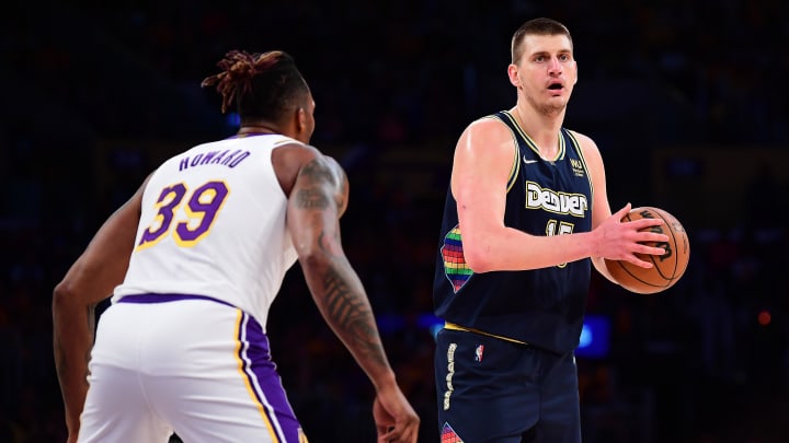 Apr 3, 2022; Los Angeles, California, USA; Denver Nuggets center Nikola Jokic (15) controls the ball against Los Angeles Lakers center Dwight Howard (39) during the first half at Crypto.com Arena.