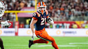 Dec 31, 2024; Orlando, FL, USA; Illinois Fighting Illini running back Aidan Laughery (21) runs the ball against South Carolina Gamecocks linebacker Debo Williams (0) in the fourth quarter at Camping World Stadium. Mandatory Credit: Jeremy Reper-Imagn Images