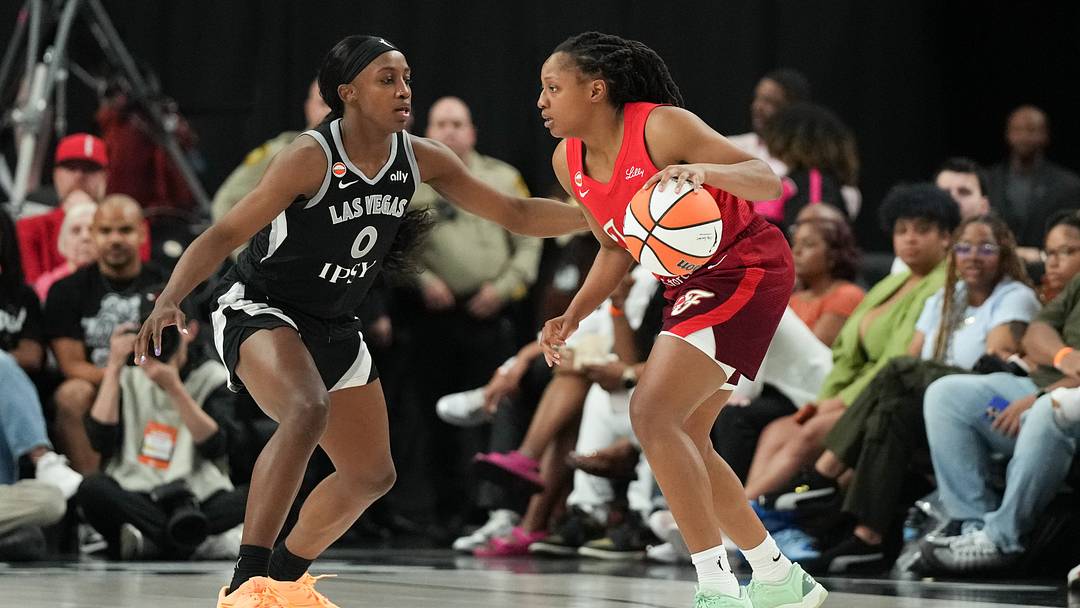 Jul 5, 2026; Las Vegas, Nevada, USA;  Indiana Fever guard Kelsey Mitchell (0) dribbles against Las Vegas Aces guard Jackie Young (0) in the second quarter of their game at T-Mobile Arena. Mandatory Credit: Candice Ward-Imagn Images
