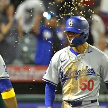 Sep 3, 2024; Anaheim, California, USA;  Los Angeles Dodgers shortstop Mookie Betts (50) is showered with seeds by left fielder Teoscar Hernandez (37) after hitting a three-run home run in the tenth inning against the Los Angeles Angels at Angel Stadium. Mandatory Credit: Jayne Kamin-Oncea-Imagn Images