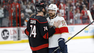 Carolina Hurricanes defenseman Jaccob Slavin congratulates Florida Panthers forward Sam Reinhart.