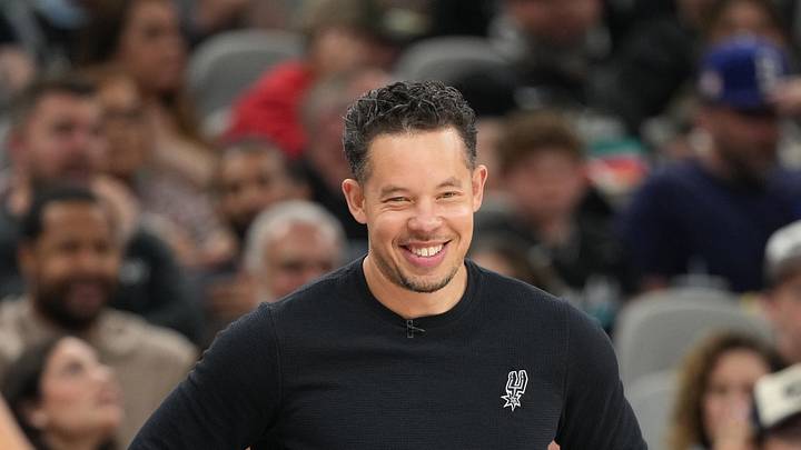 Apr 8, 2026; San Antonio, Texas, USA; San Antonio Spurs head coach Mitch Johnson smiles during the first half against the Portland Trail Blazers at Frost Bank Center. Mandatory Credit: Scott Wachter-Imagn Images