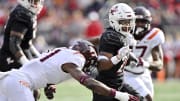 Nov 4, 2023; Louisville, Kentucky, USA;  Louisville Cardinals running back Jawhar Jordan (25) runs the ball against Virginia Tech Hokies linebacker Keli Lawson (21) during the first quarter at L&N Federal Credit Union Stadium. Mandatory Credit: Jamie Rhodes-USA TODAY Sports