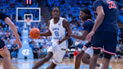 Nov 11, 2025; Chapel Hill, North Carolina, USA; North Carolina Tar Heels forward Caleb Wilson (8) drives past Radford Highlanders guard Jr. Dennis Parker (11) during the second half at Dean E. Smith Center. 