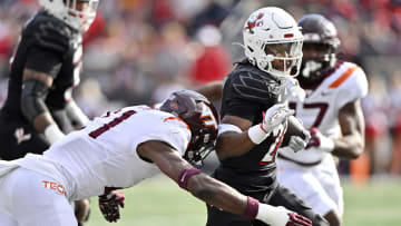 Nov 4, 2023; Louisville, Kentucky, USA;  Louisville Cardinals running back Jawhar Jordan (25) runs the ball against Virginia Tech Hokies linebacker Keli Lawson (21) during the first quarter at L&N Federal Credit Union Stadium. Mandatory Credit: Jamie Rhodes-USA TODAY Sports