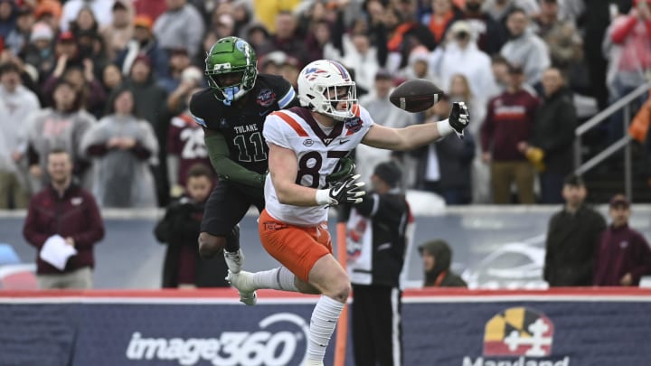 Dec 27, 2023; Annapolis, MD, USA;  Tulane Green Wave defensive back A.J. Hampton Jr. (11) breaks upon a pass intended for Virginia Tech Hokies tight end Harrison Saint Germain (87) during the first half at Navy-Marine Corps Memorial Stadium. Mandatory Credit: Tommy Gilligan-USA TODAY Sports