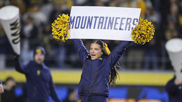 Nov 23, 2024; Morgantown, West Virginia, USA; A West Virginia Mountaineers cheerleader performs during the third quarter against the UCF Knights at Mountaineer Field at Milan Puskar Stadium. Mandatory Credit: Ben Queen-Imagn Images