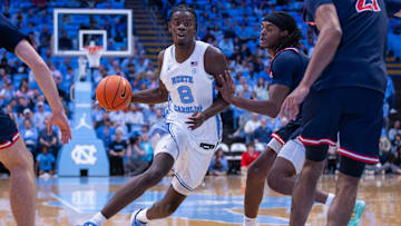 Nov 11, 2025; Chapel Hill, North Carolina, USA; North Carolina Tar Heels forward Caleb Wilson (8) drives past Radford Highlanders guard Jr. Dennis Parker (11) during the second half at Dean E. Smith Center. Mandatory Credit: Scott Kinser-Imagn Images
