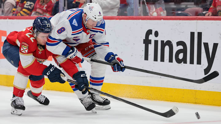 Apr 13, 2026; Sunrise, Florida, USA; New York Rangers center J.T. Miller (8) moves the puck against Florida Panthers defenseman Tobias Bjornfot (22) during the second period at Amerant Bank Arena. 