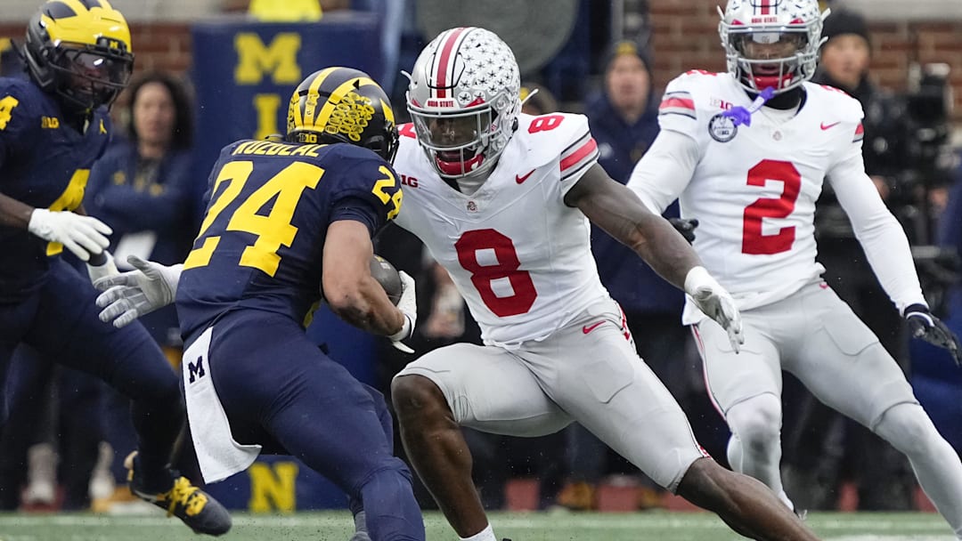 Ohio State Buckeyes linebacker Arvell Reese (8) tackles Michigan Wolverines running back Bryson Kuzdzal (24) during the NCAA football game at Michigan Stadium in Ann Arbor, Mich. on Nov. 29, 2025. Ohio State won 27-9.